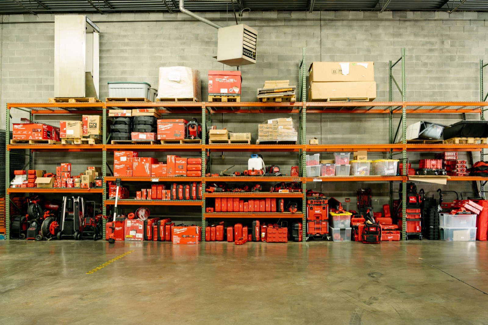 Milwaukee professional tools and equipment organized on warehouse shelving